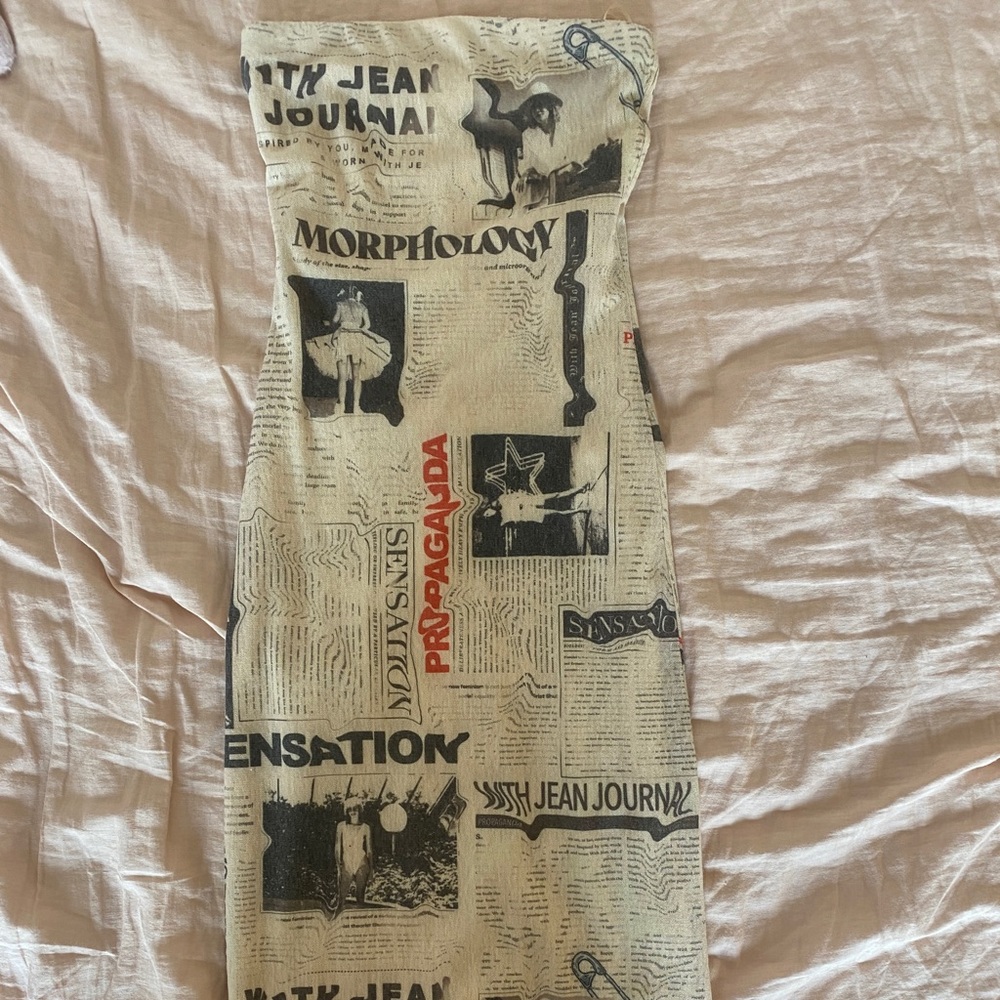 With Jean newspaper print strapless midi dress.